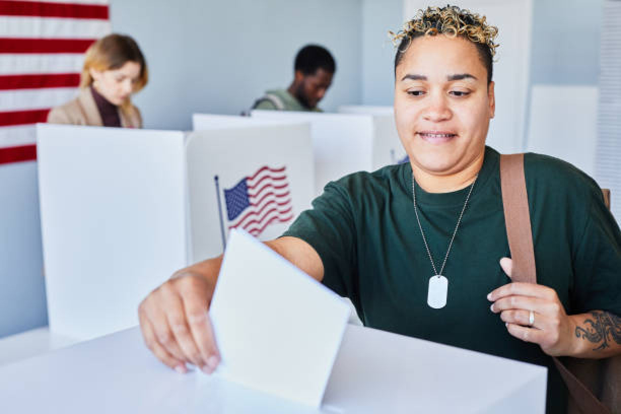 Woman casting a voting ballot